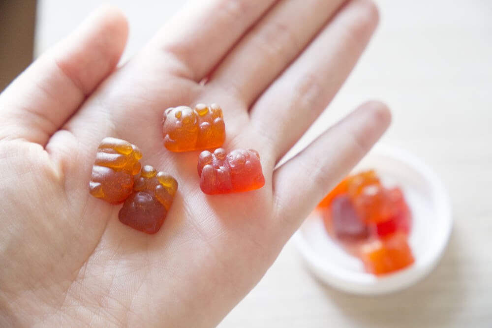 Child's hand holding gummy vitamins