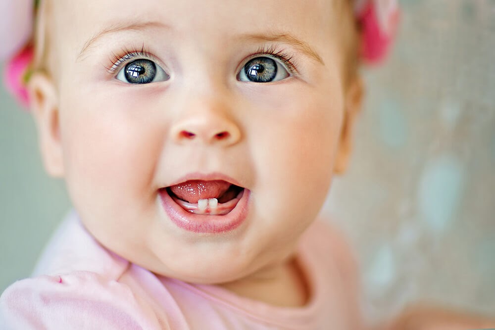 Baby girl with two bottom teeth