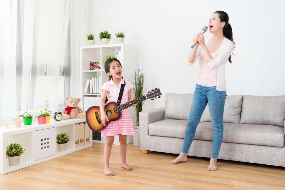 Mom and daughter playing in a band in their living room