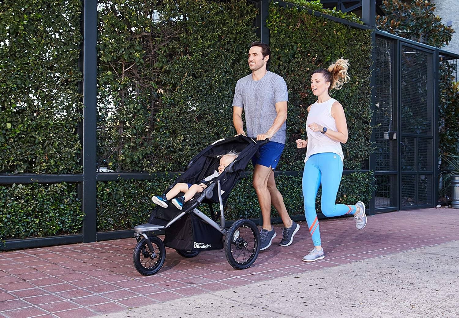 Couple running with stroller