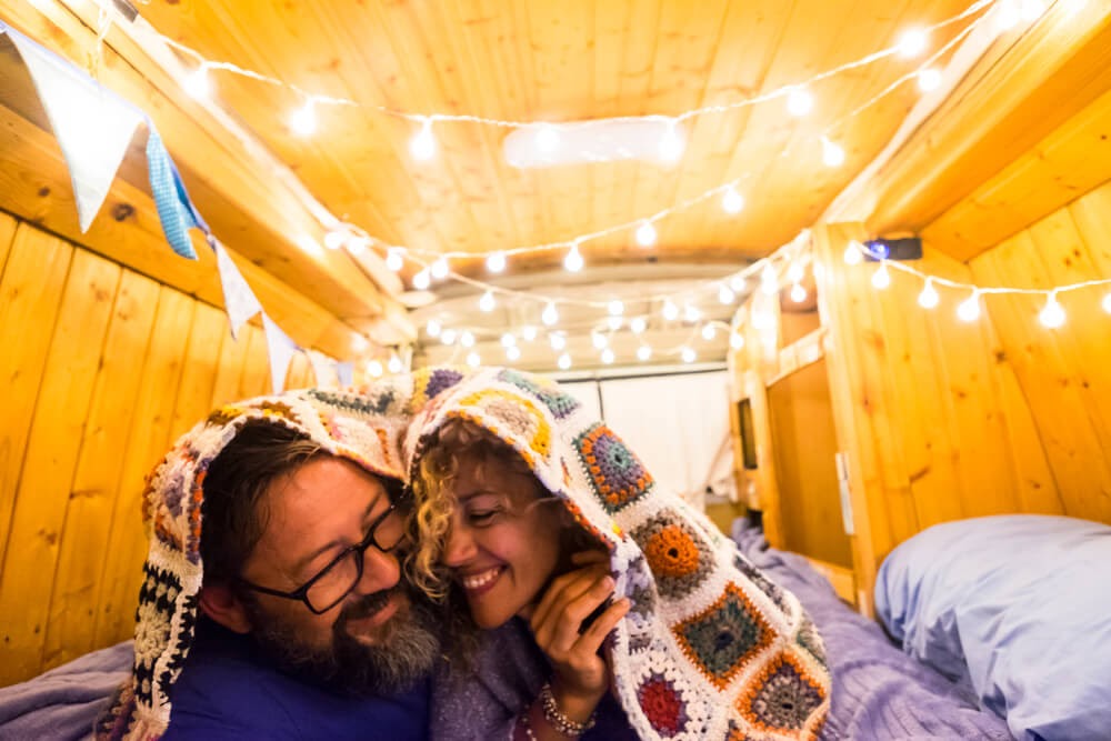 couple under a blanket in a tiny home
