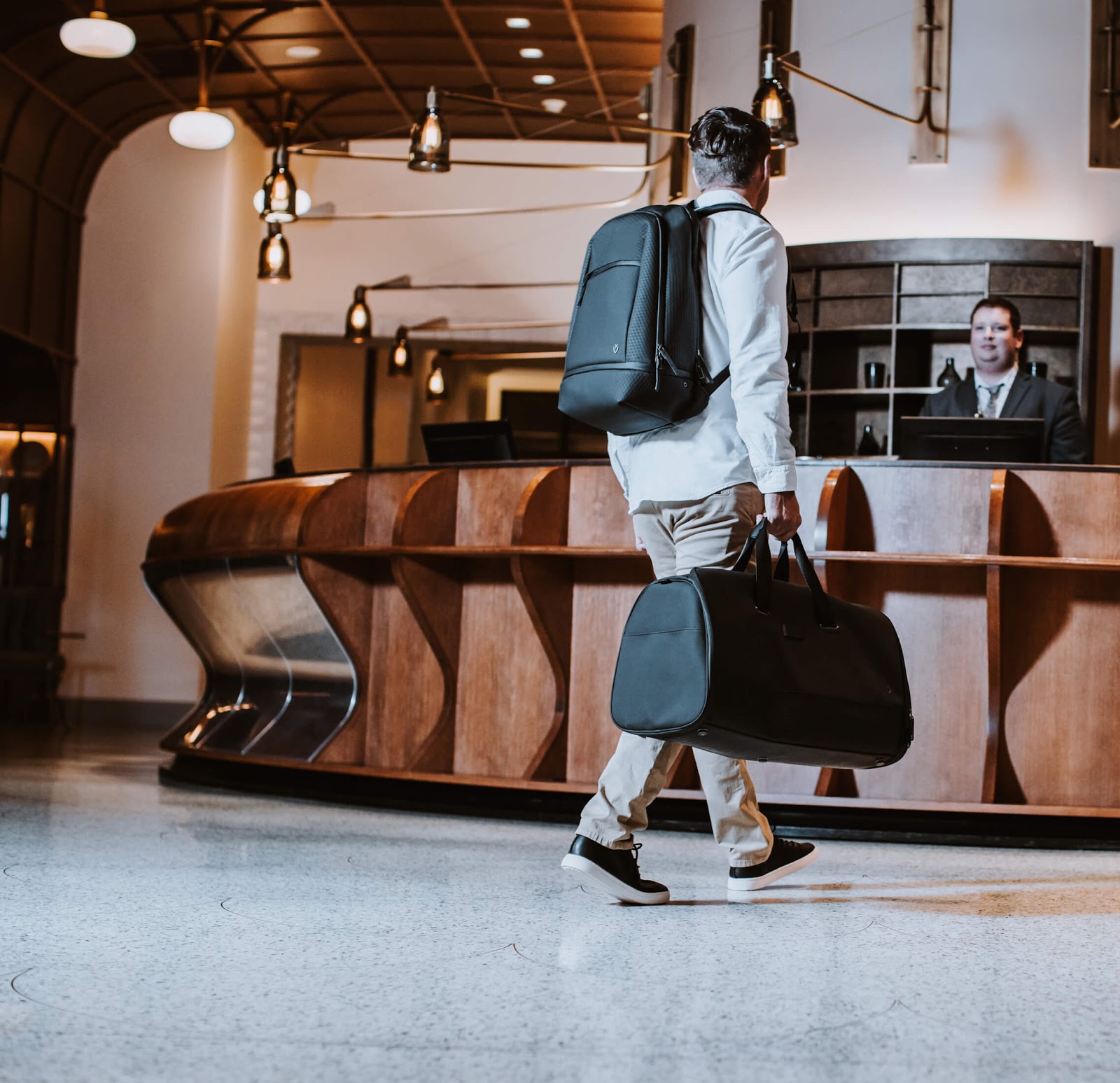 Man with vessel bag checking into a hotel