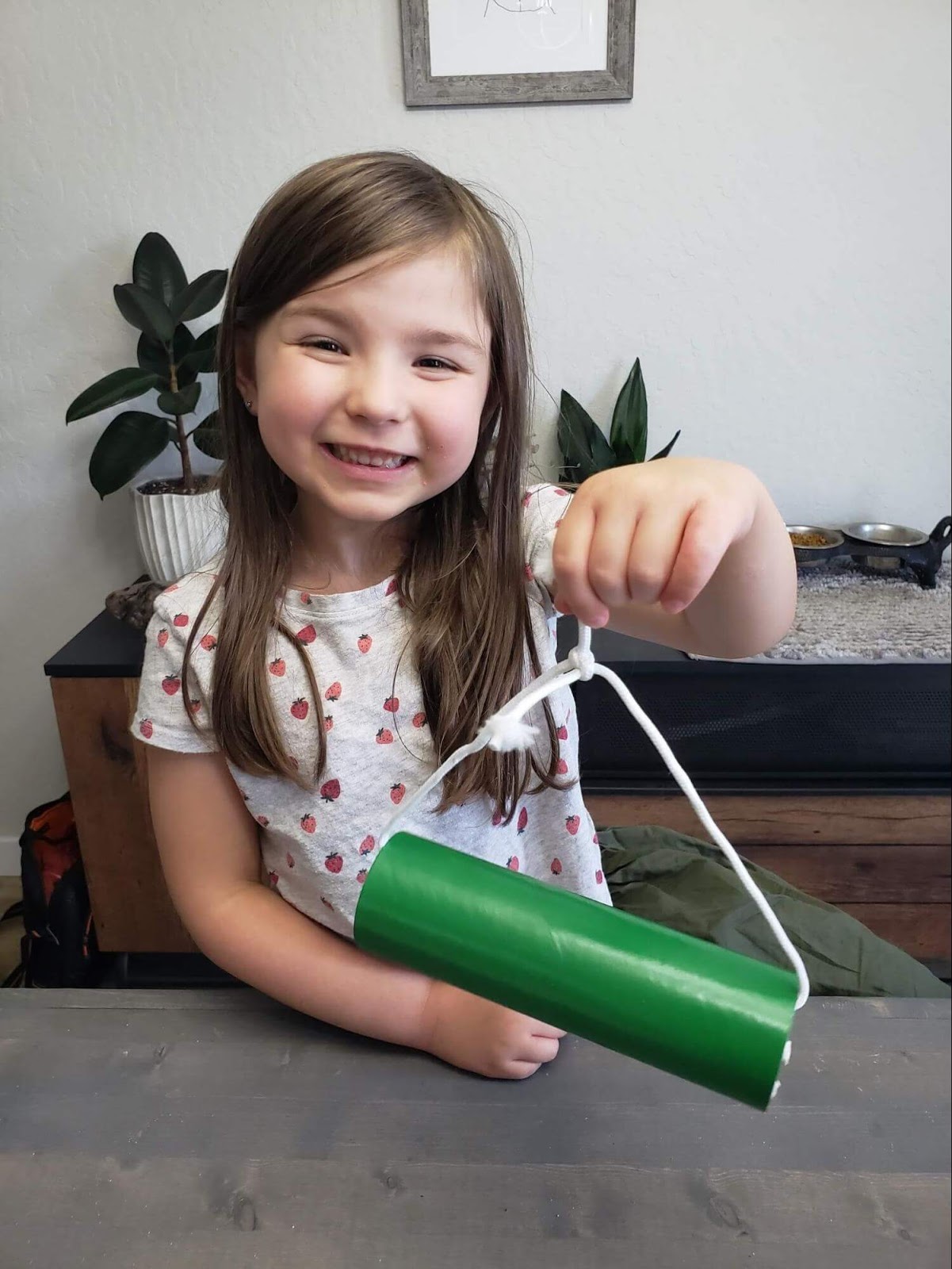 Girl holding up completed mason bee home