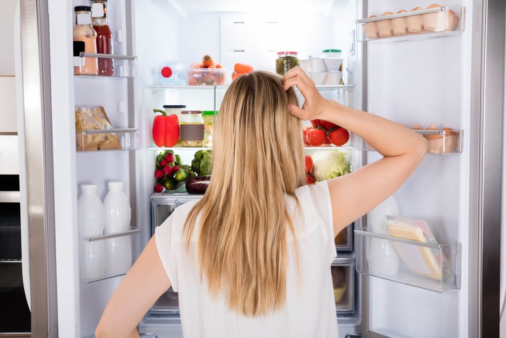 Woman looking in fridge