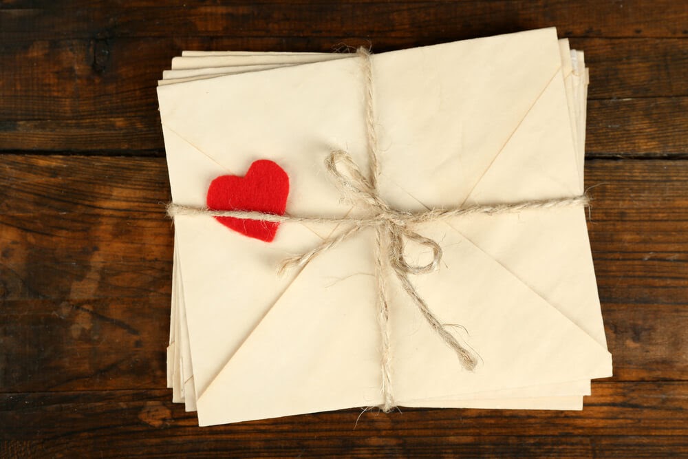 envelopes wrapped in twine with red felt heart