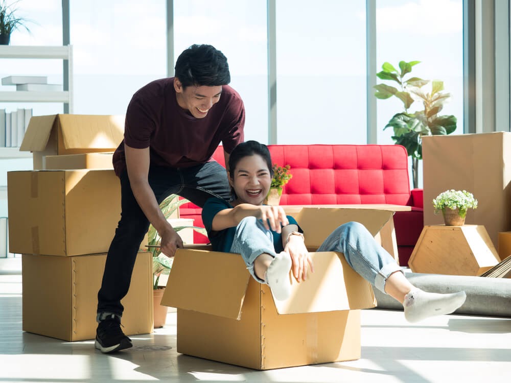 Couple playing in moving boxes