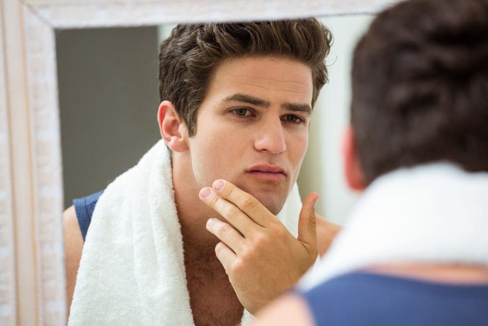Man looking at himself in the mirror