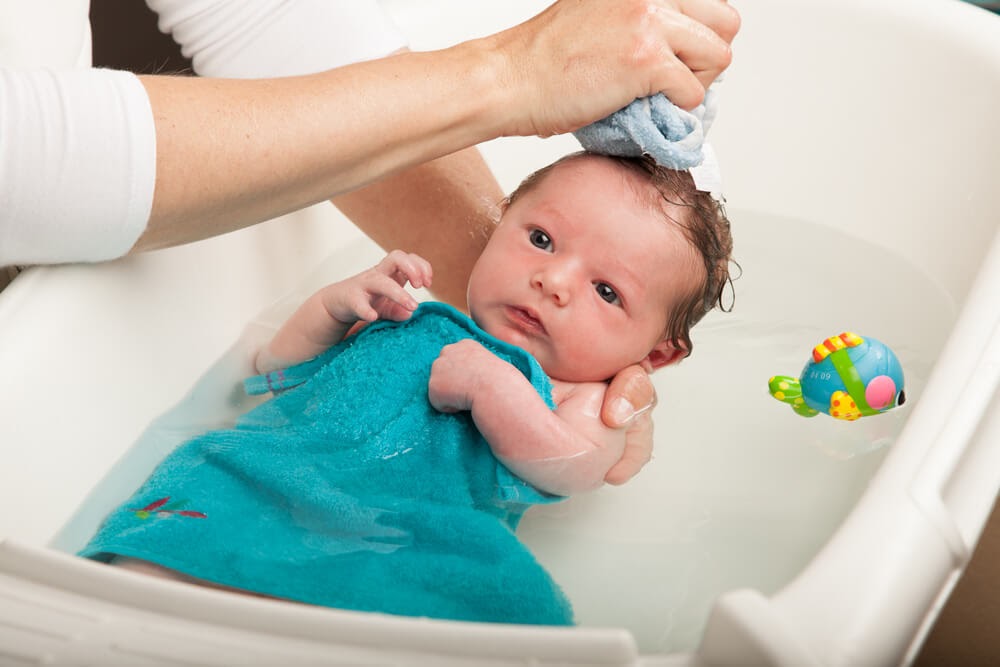 Newborn getting a bath
