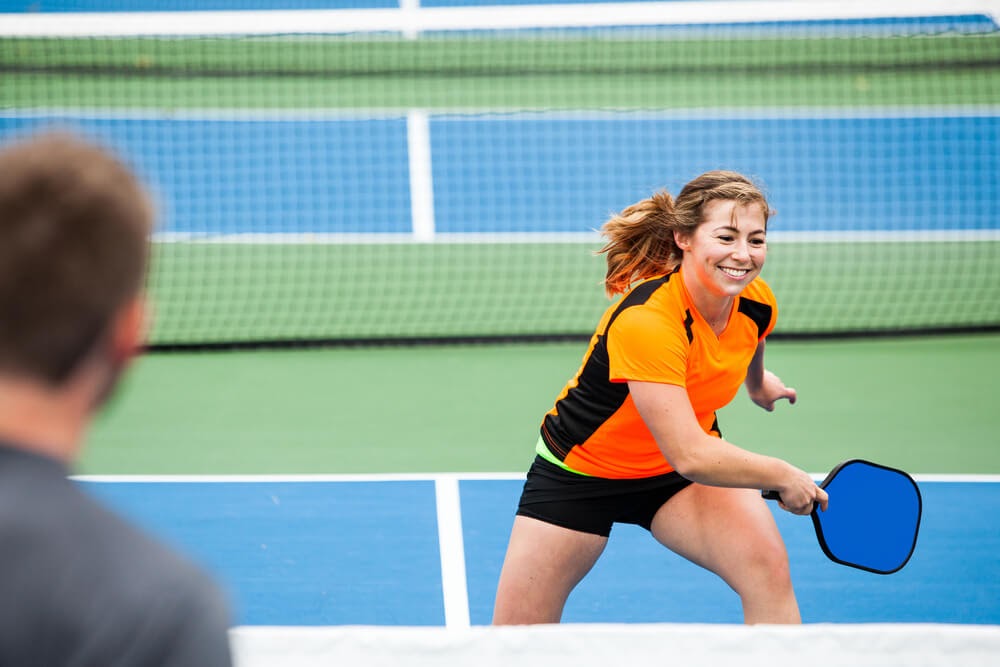 Man and woman playing pickleball