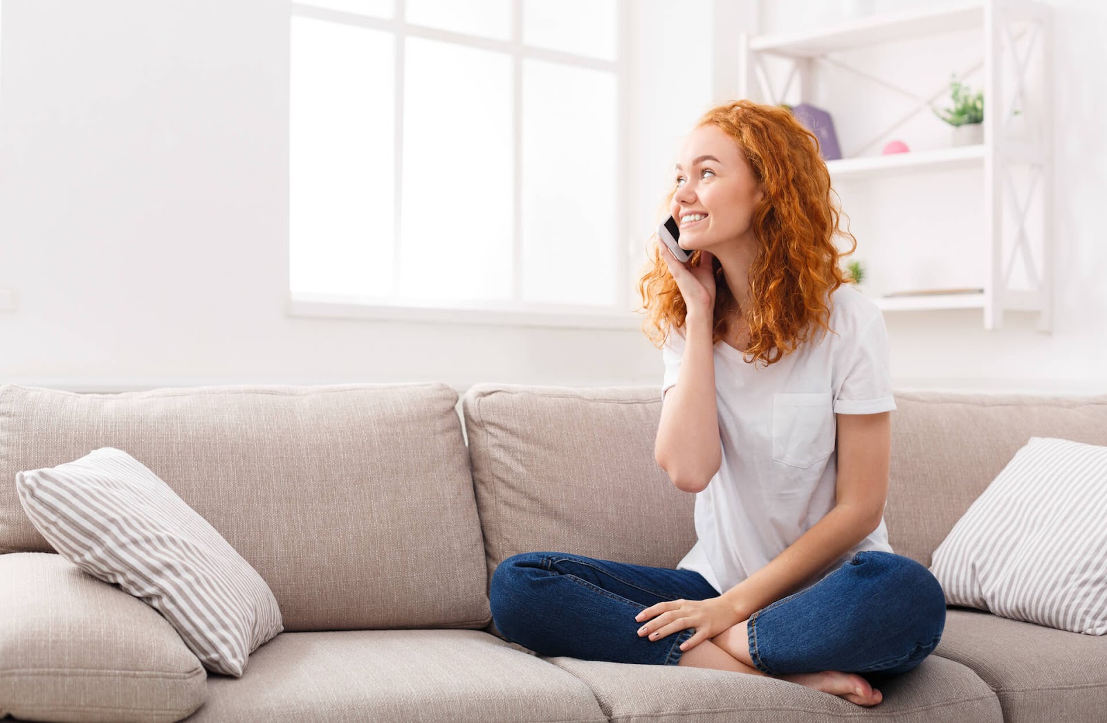 Woman talking on her cell in her living room
