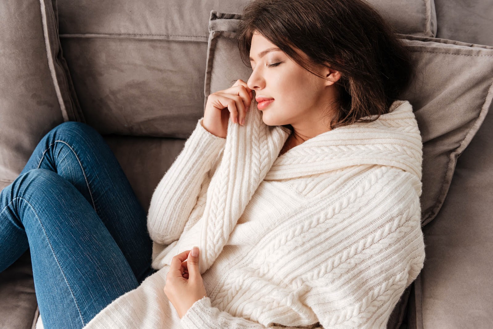Woman cuddled up on couch