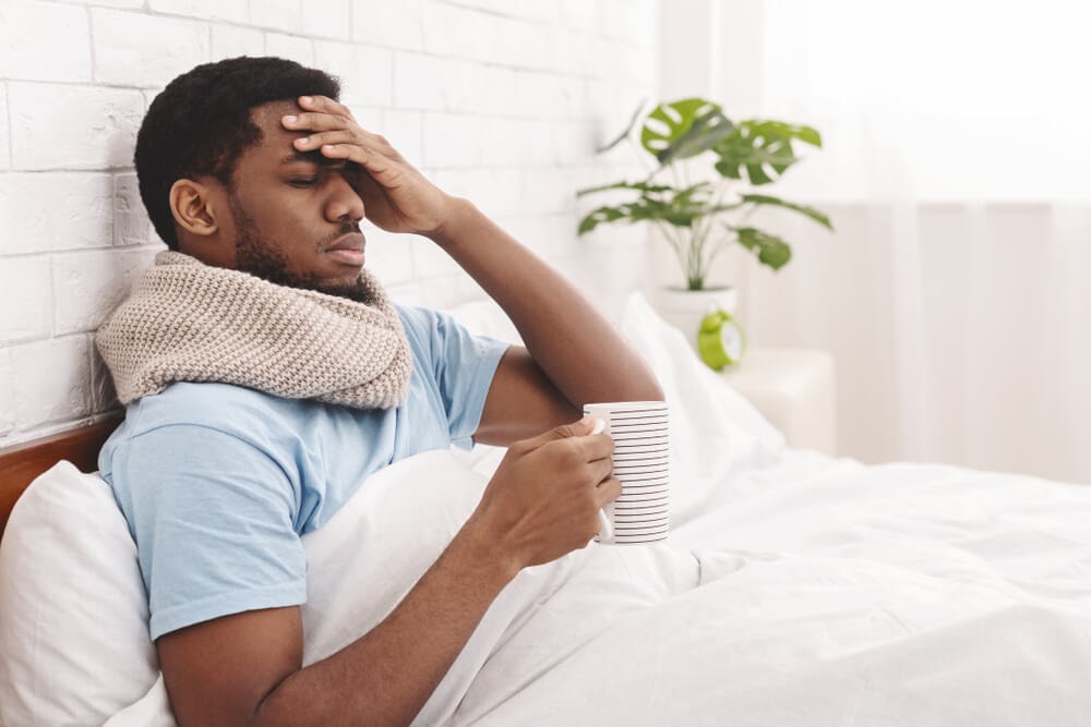 Man in bed with a cold