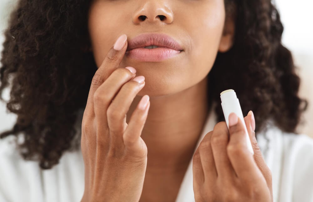 Woman putting chapstick on