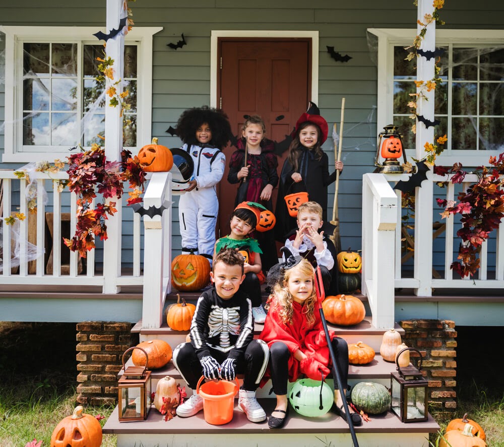 Group of children on the front porch dressed up in costume