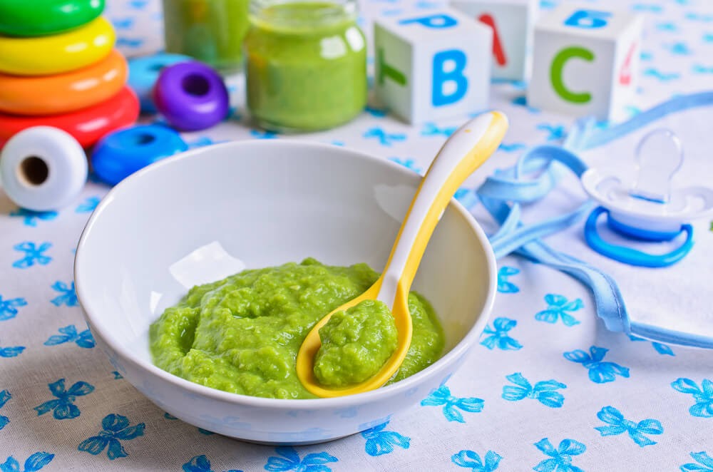 Close up of mashed up avocado in a baby bowl