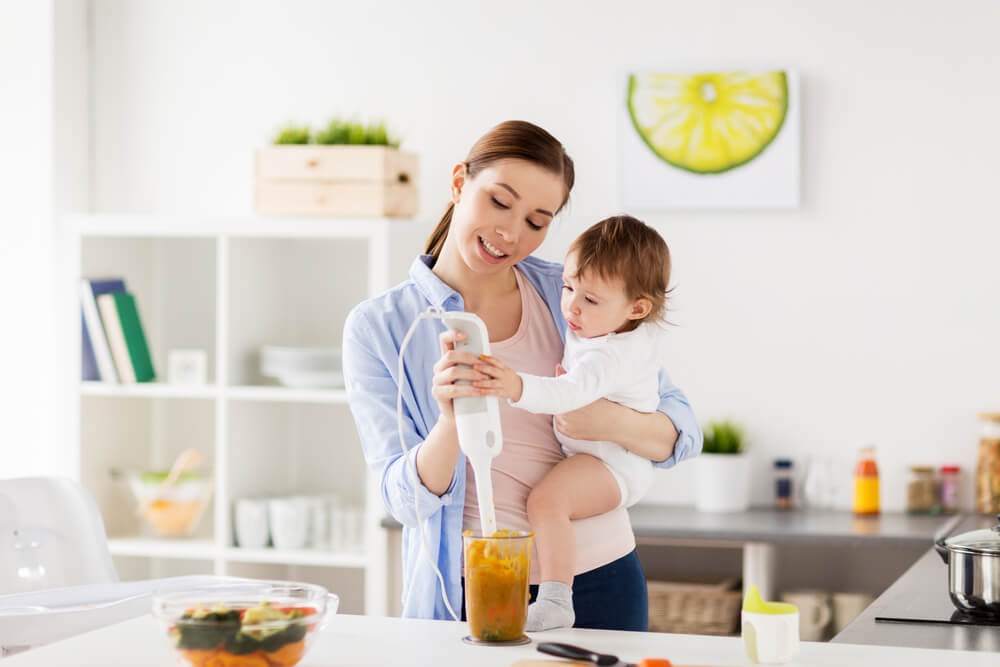 Mom and baby pureeing food together