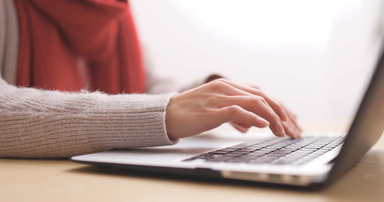 Close up of woman's hand on laptop