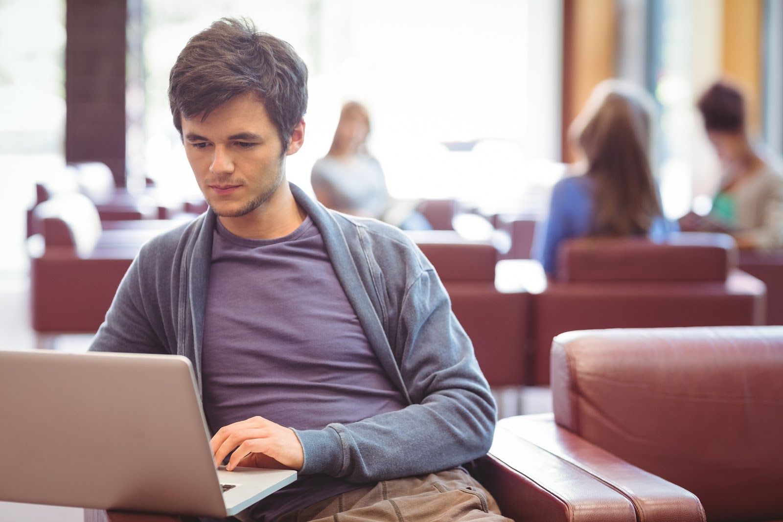 Man working on his Chromebook in a lounge