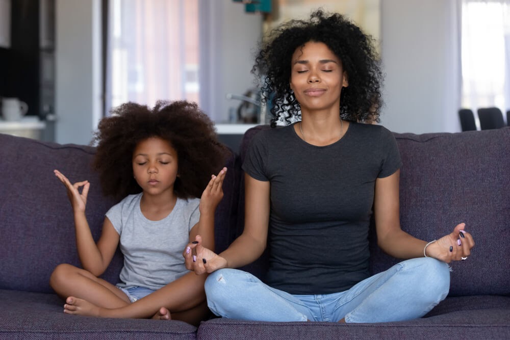 Mom and daughter meditating