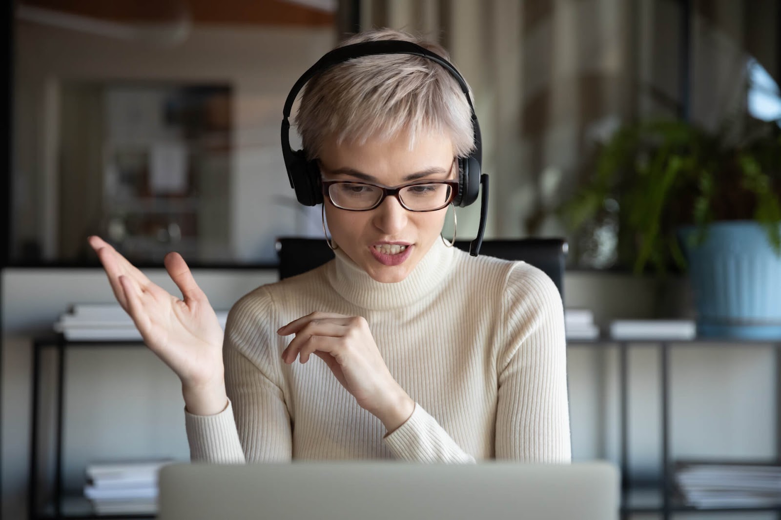 Woman recording a podcast on her laptop
