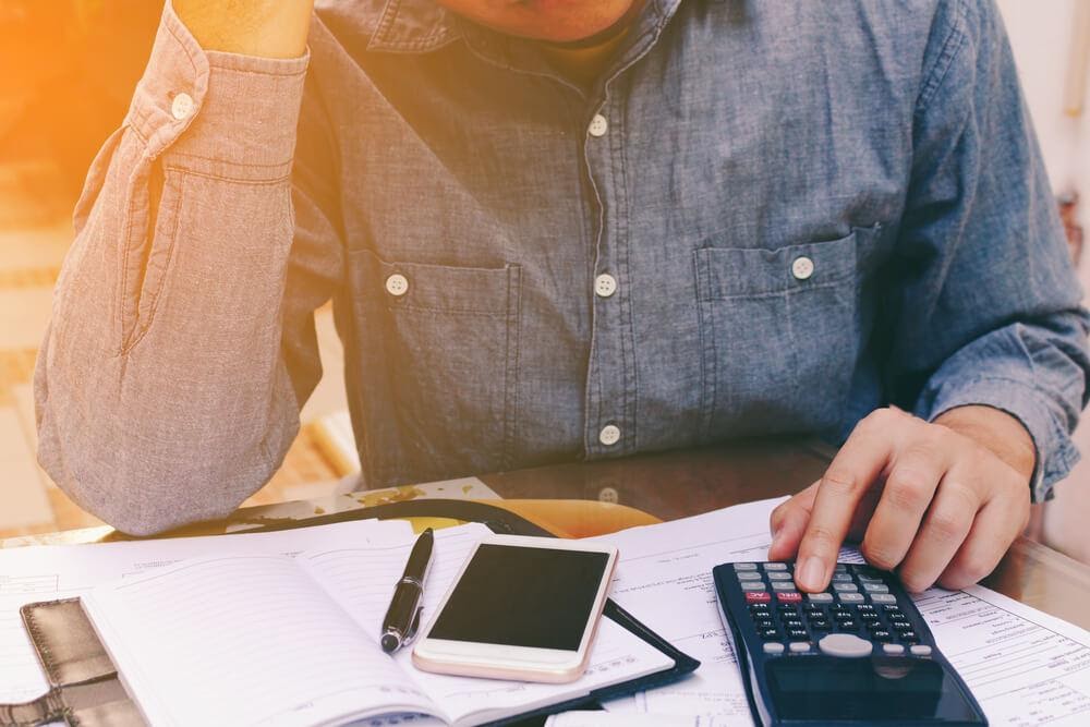 man using a calculator