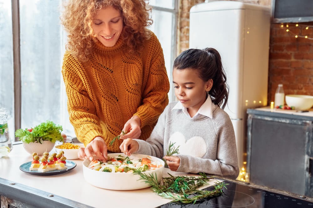 Young woman and child preparing a Thanksgiving dish
