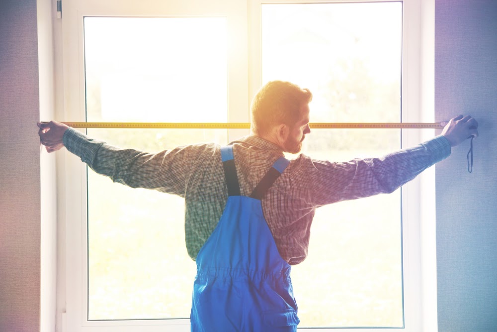 Man measuring window