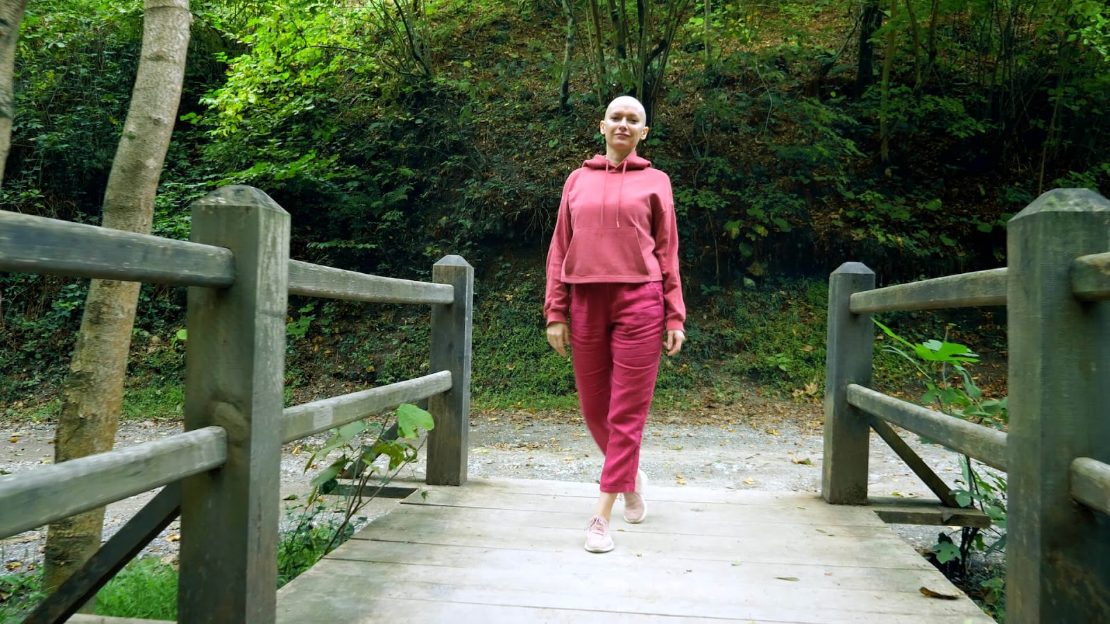 Woman with cancer walking through the park