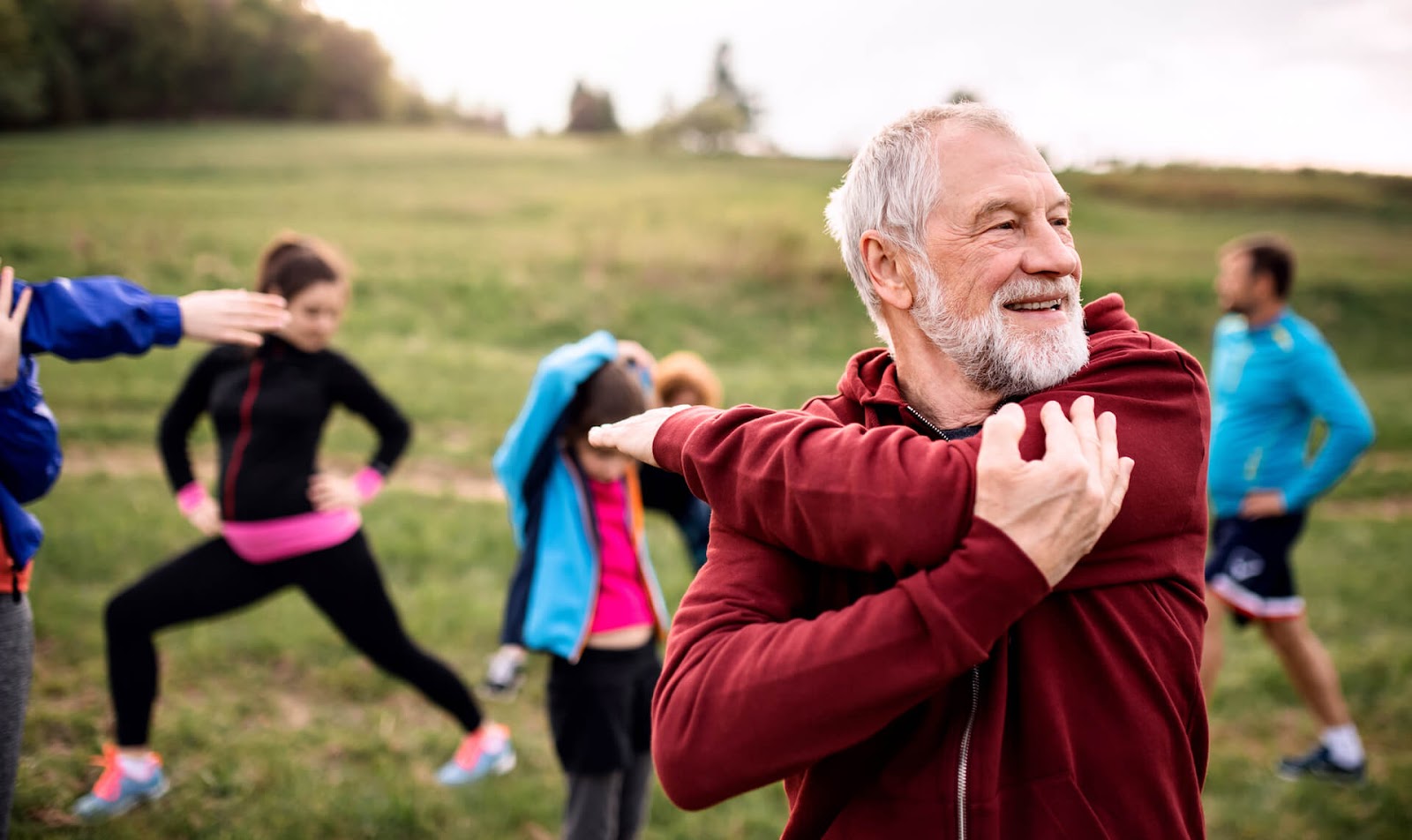 Man stretching during a group outdoor exercise session