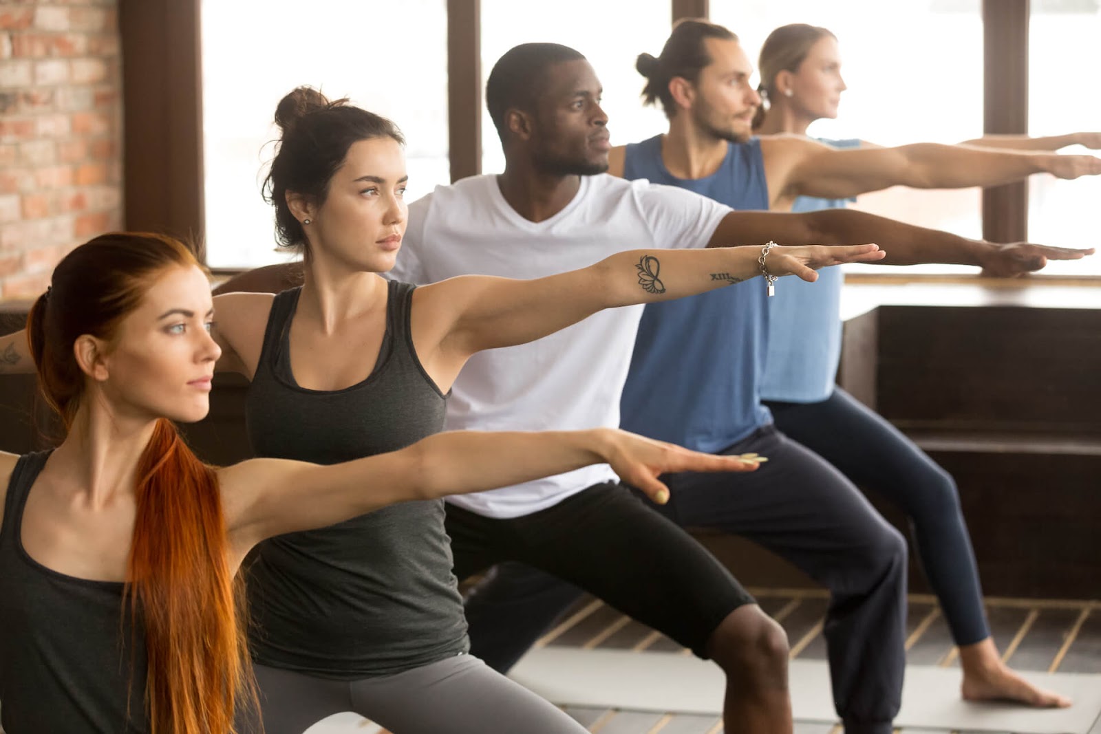 Group of people doing yoga in a studio