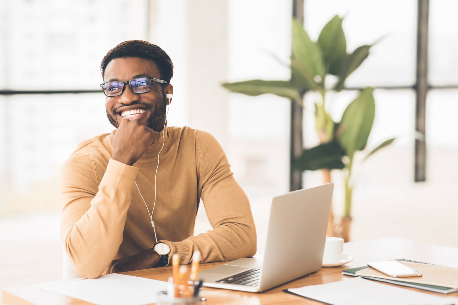 Man listening to music while working on a laptop