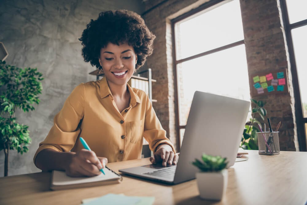 Woman writing at her desk