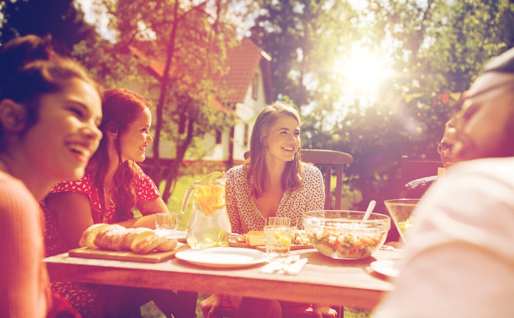 Woman listening to friends at a dinner party