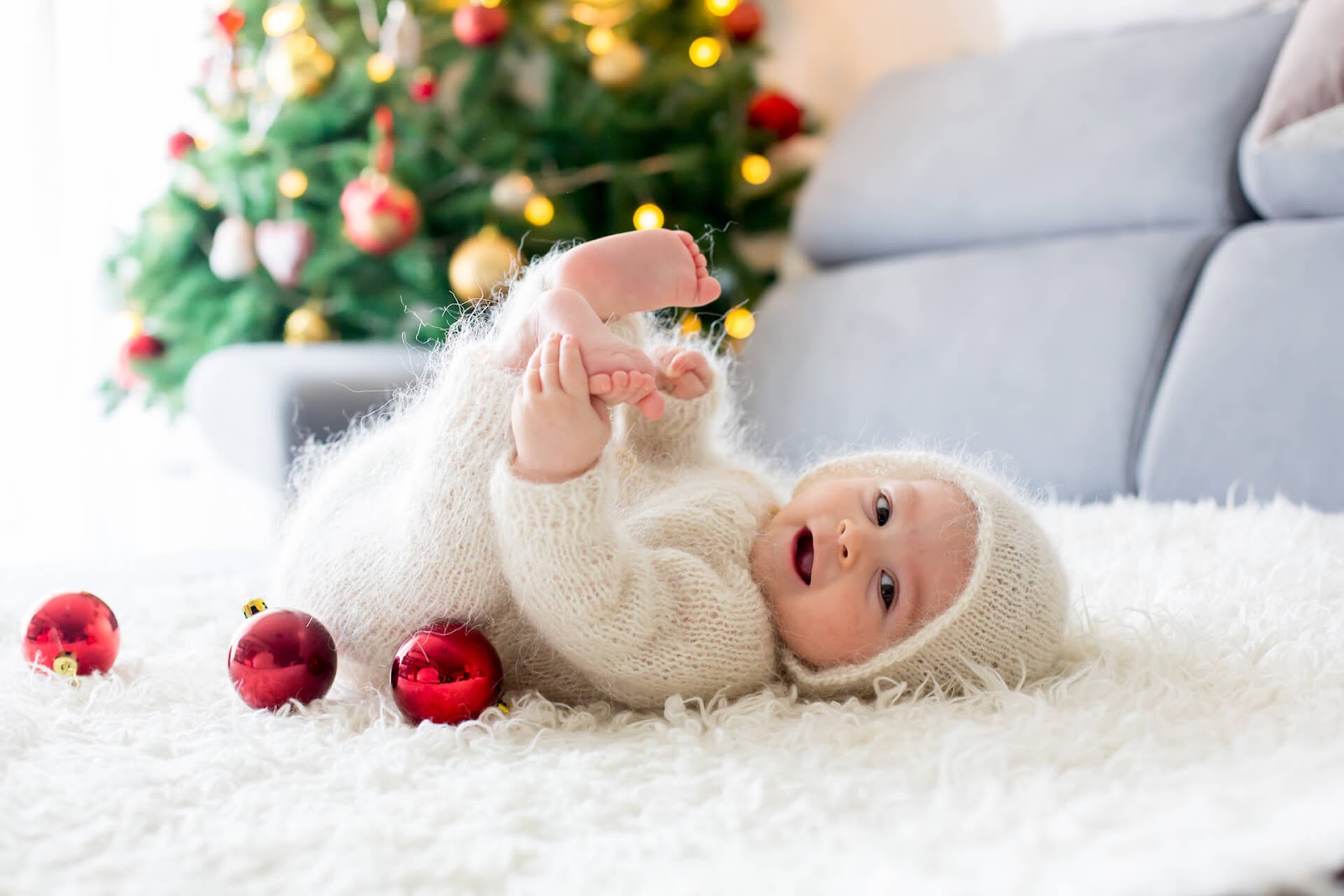 Baby in fuzzy onesie on the floor