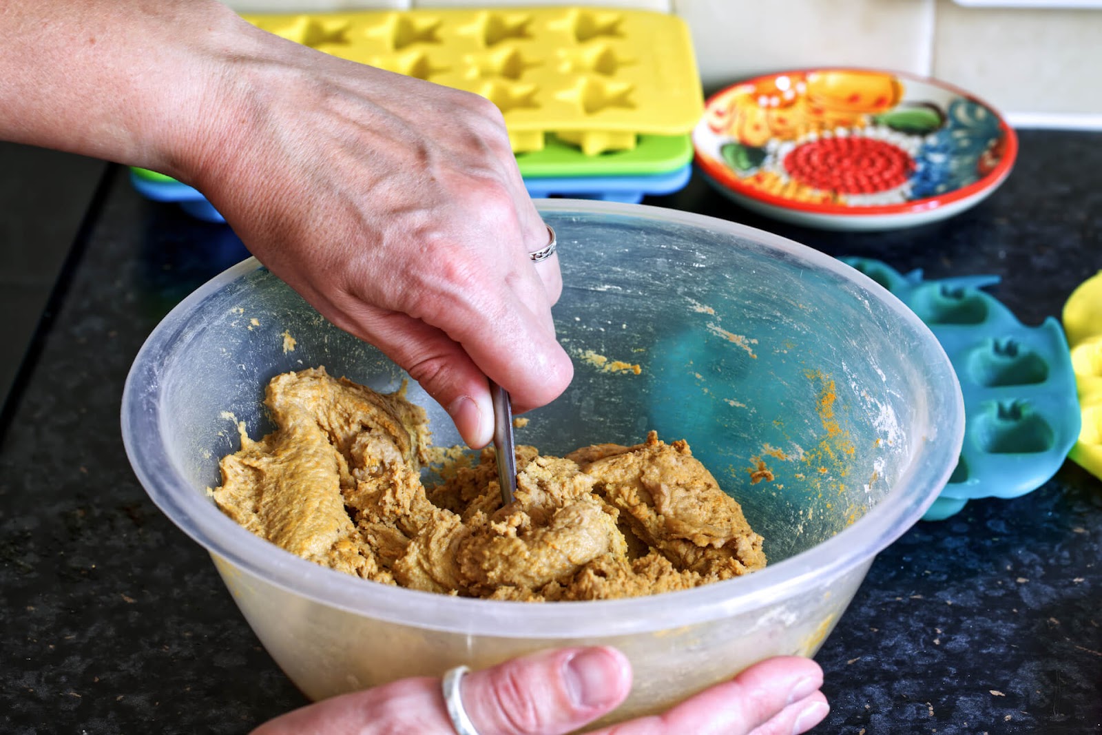 Person mixing ingredients in bowl