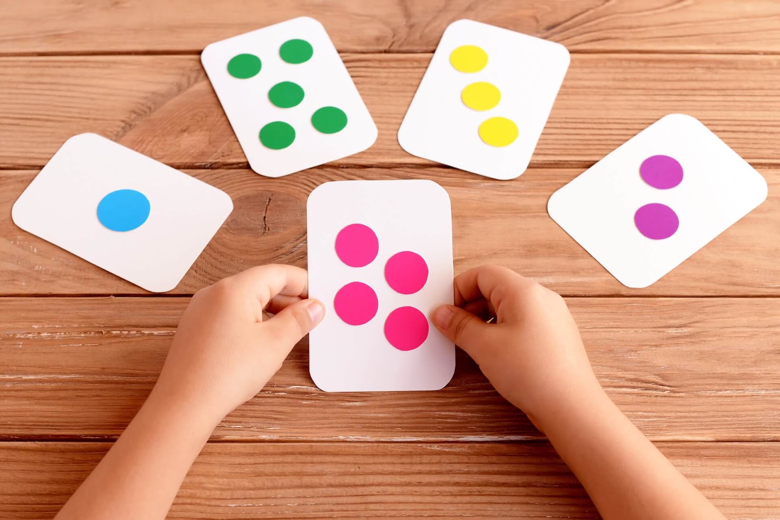 Child Playing with Number Cards