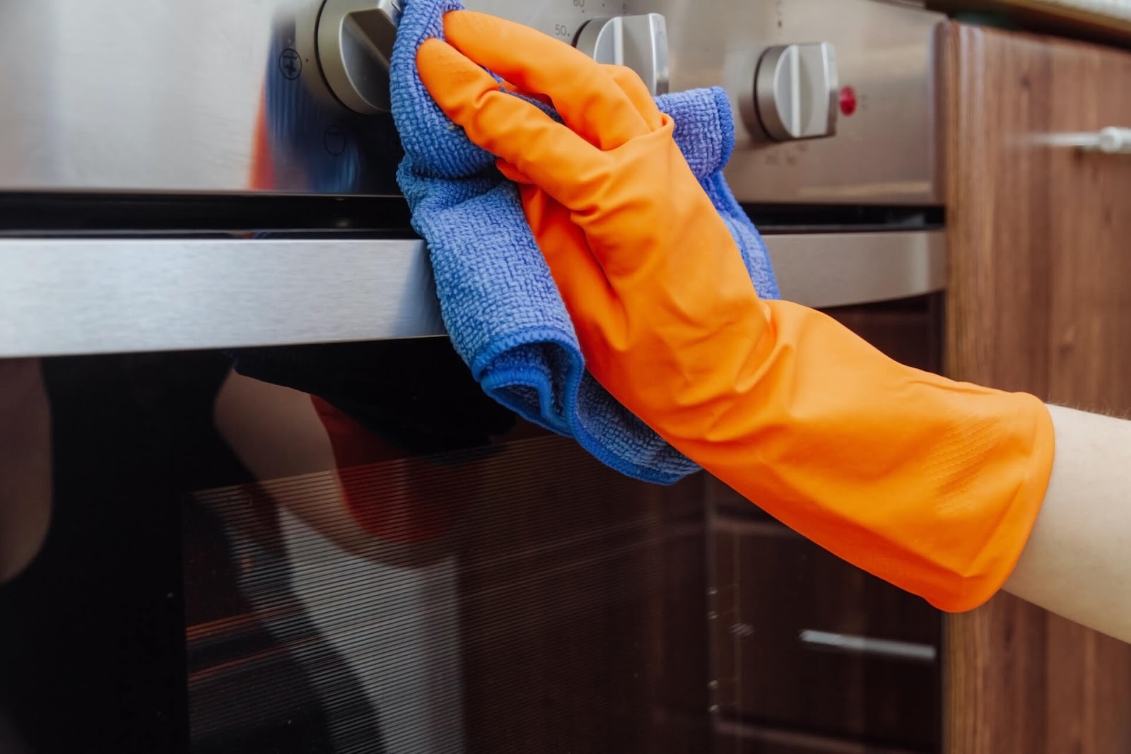 close up of gloved hand cleaning knobs