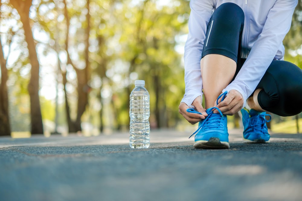 Woman putting on her running shoes