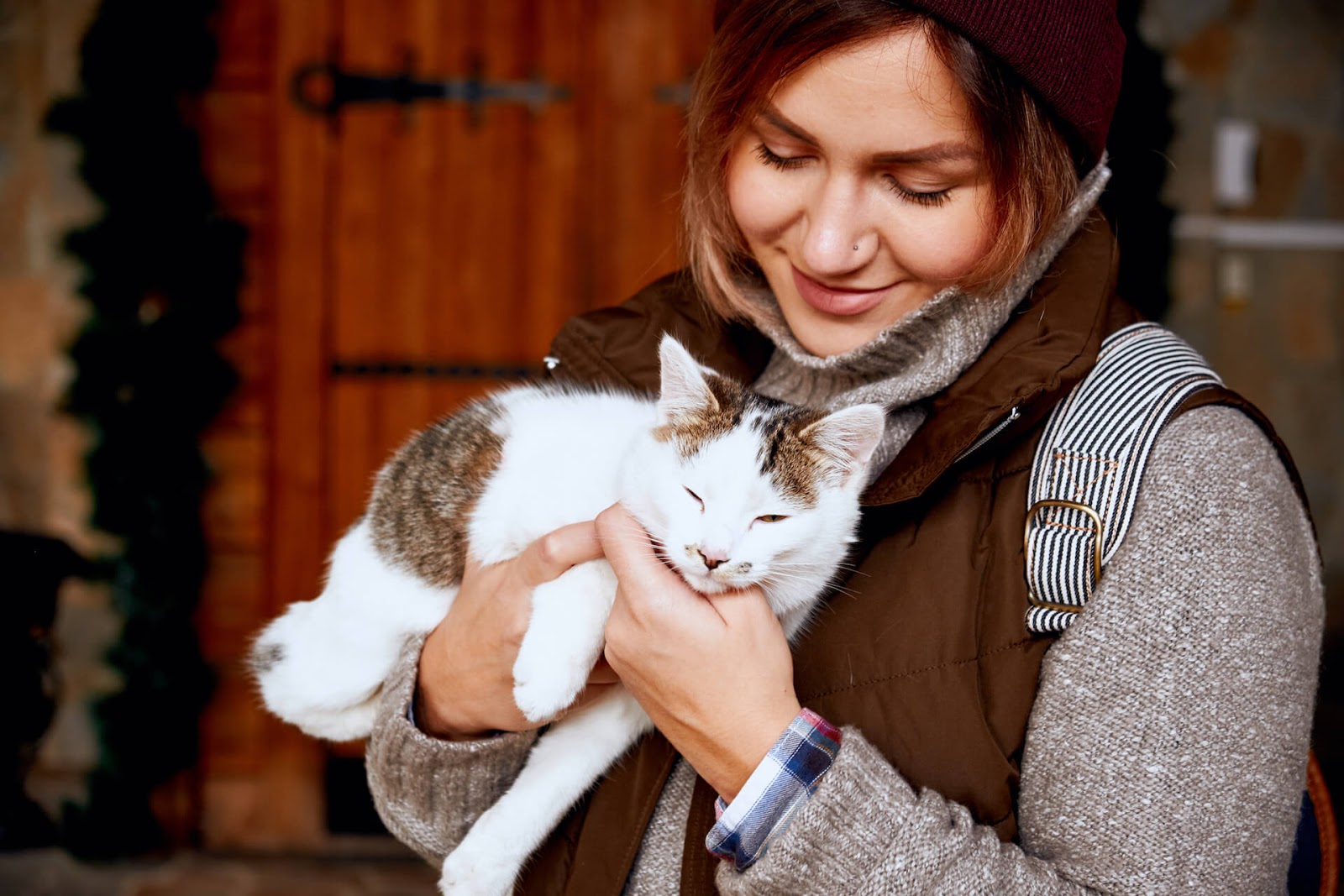Woman volunteering and cuddling cats