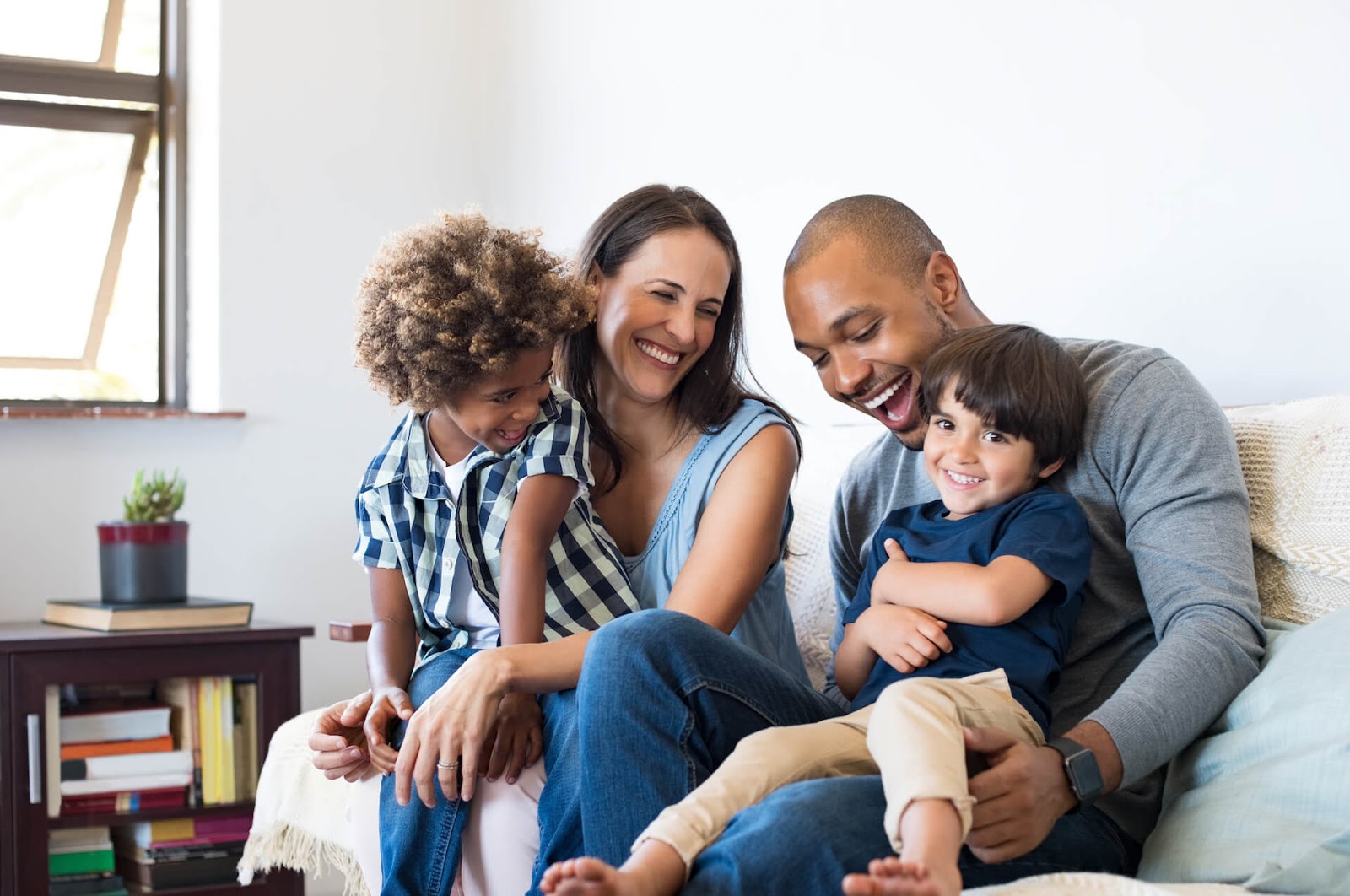 Family laughing on the couch