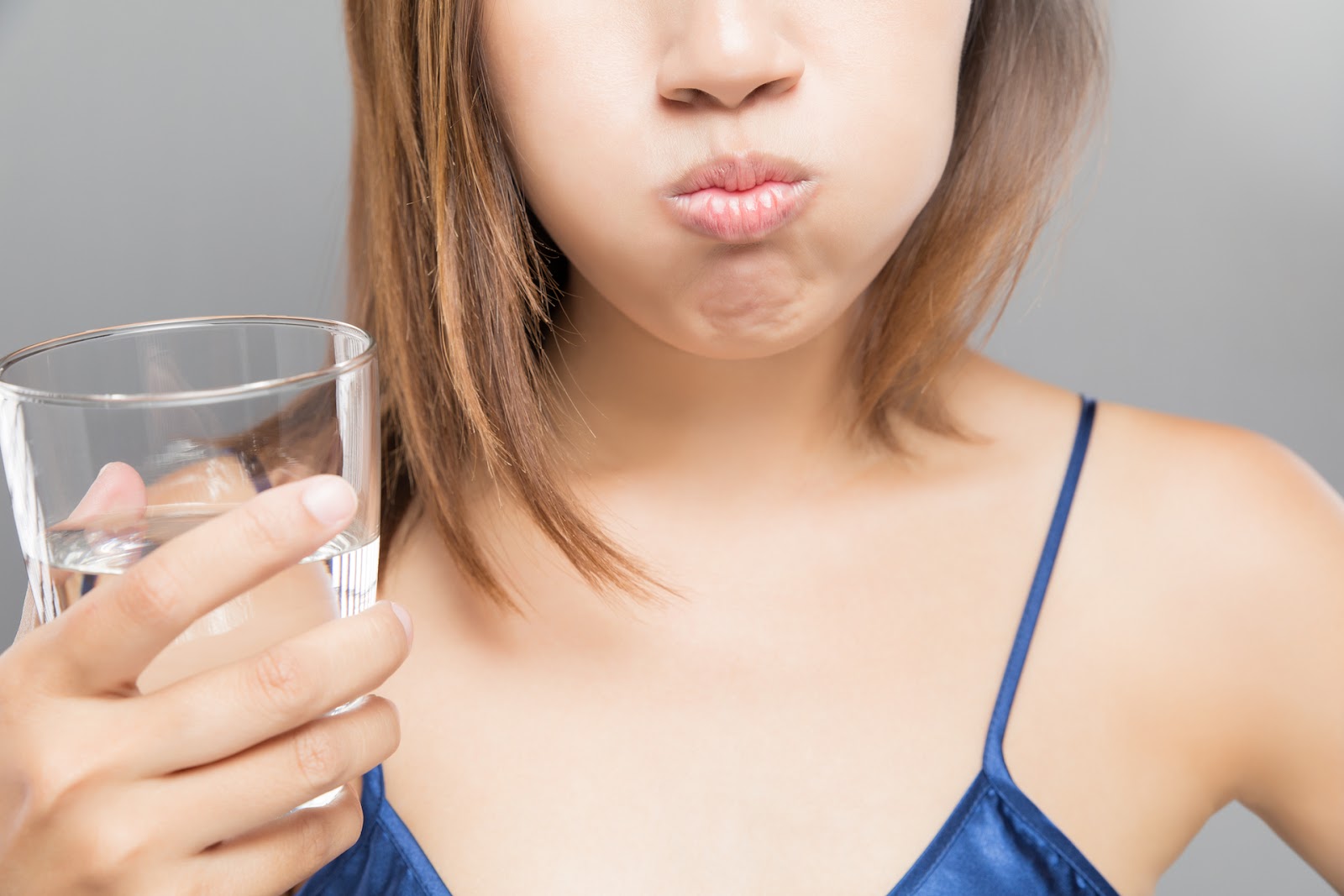 Woman swishing coconut oil in her mouth