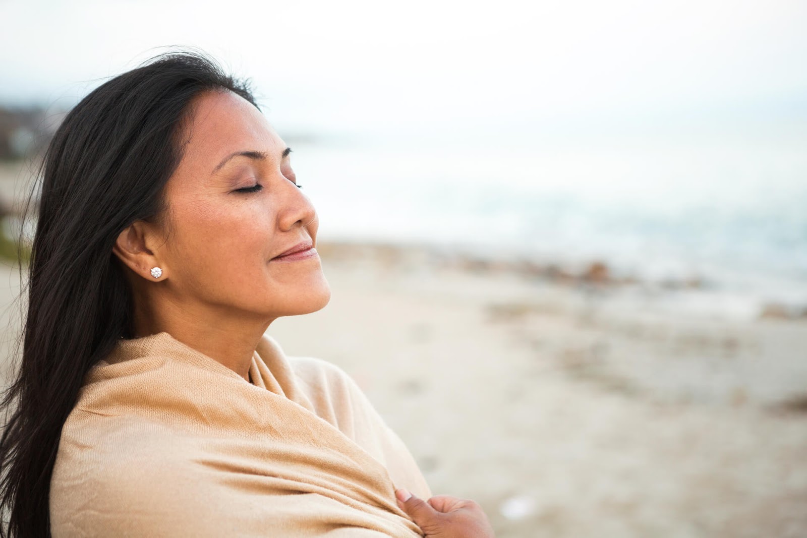 Woman soaking in the moment at the beach