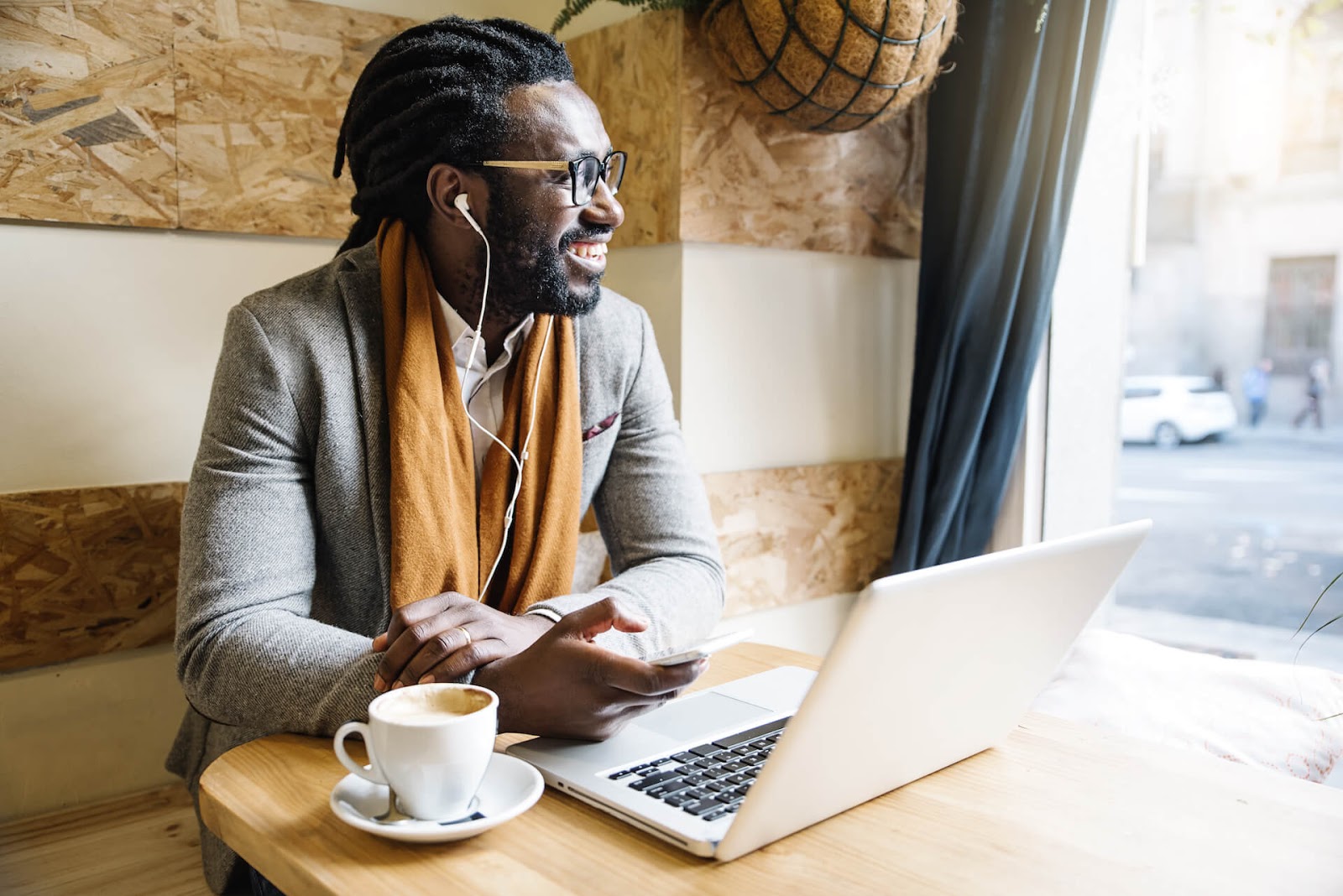 Man smiling while working at a coffee shop