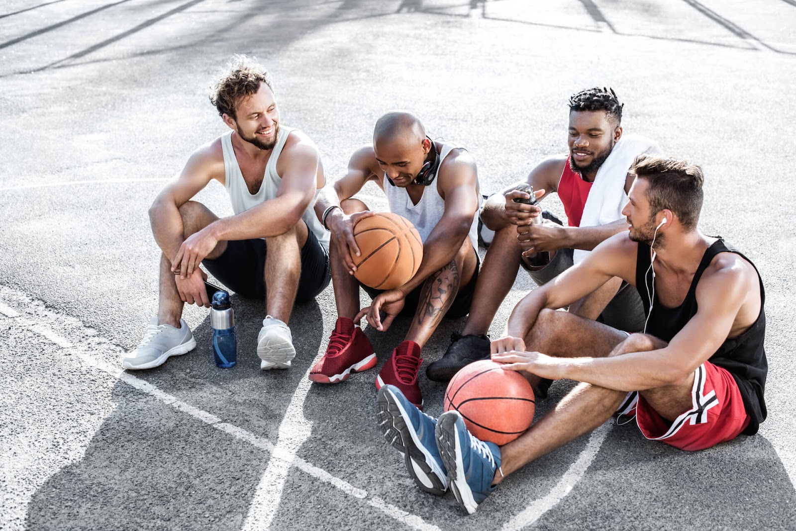 Group of guys resting after a basket ball game