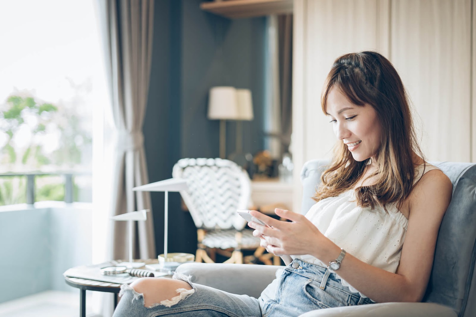 Woman looking at her phone on the couch