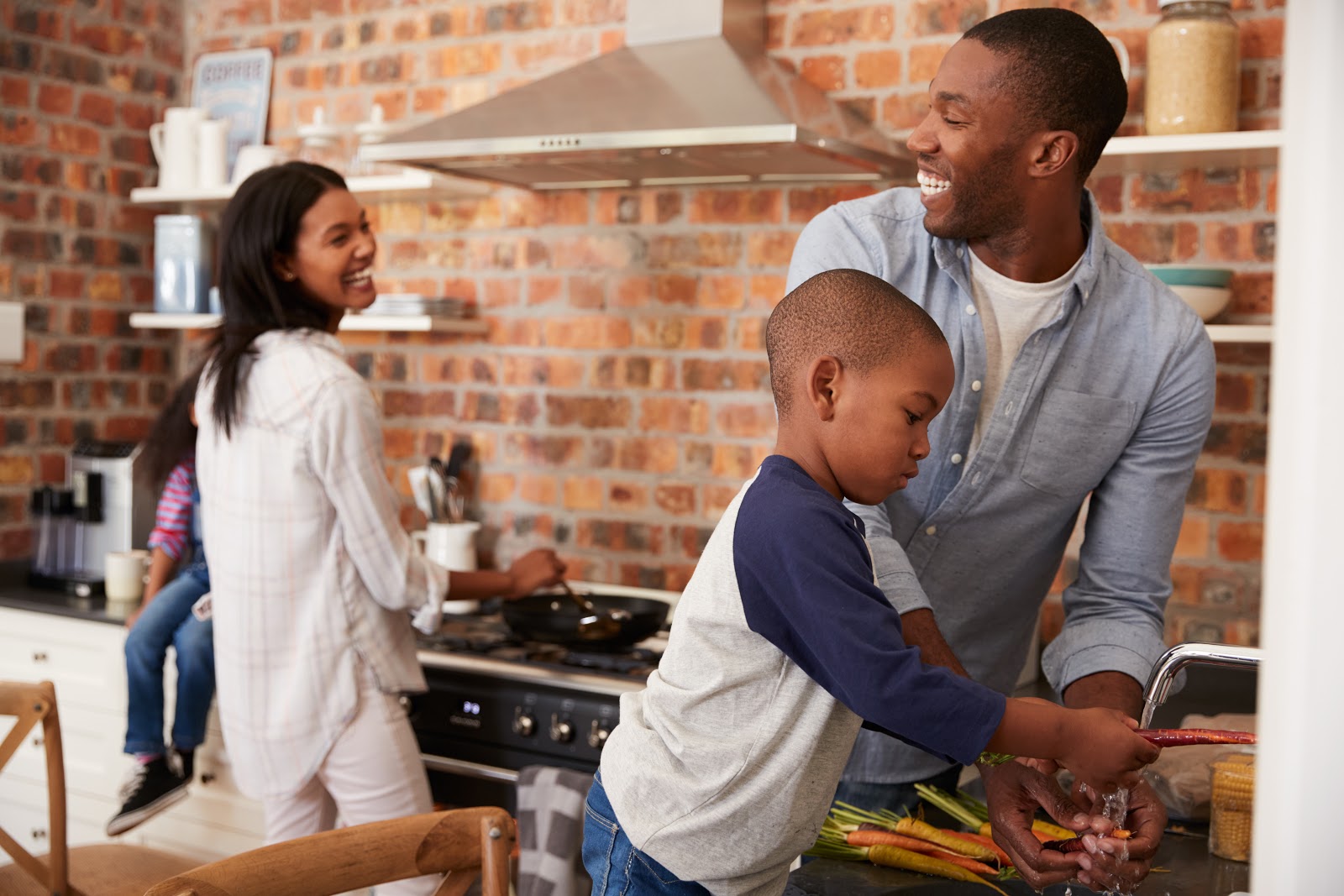 Family cooking in the kitchen together and laughing