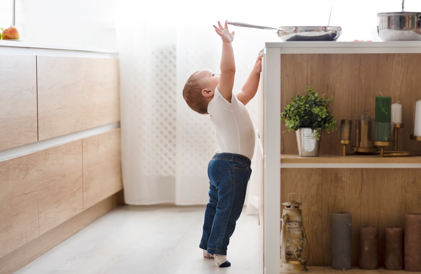 Toddler reaching for pan on the counter