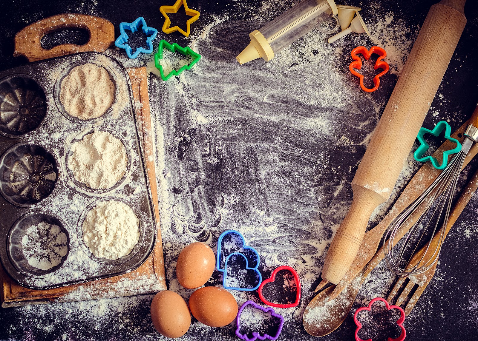 Birdseye view of counter with cookie dough and cookie cutters