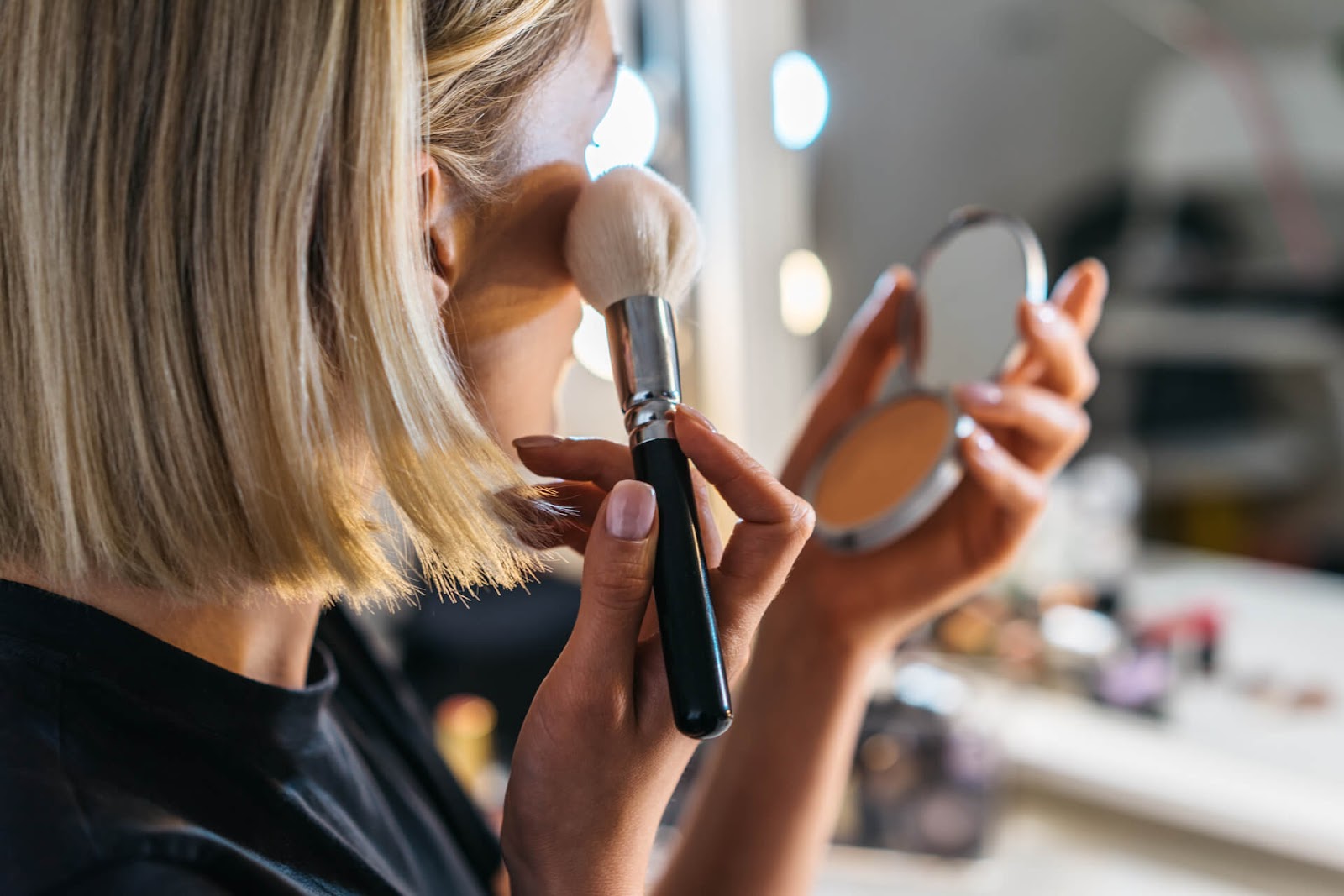 Woman putting on her own makeup