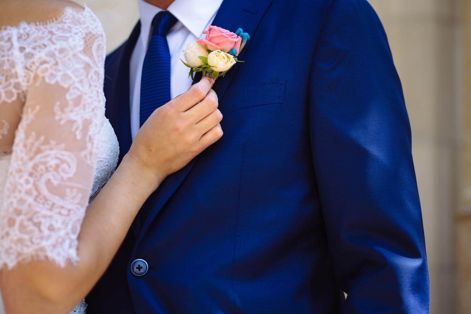 Woman straightening man's corsage